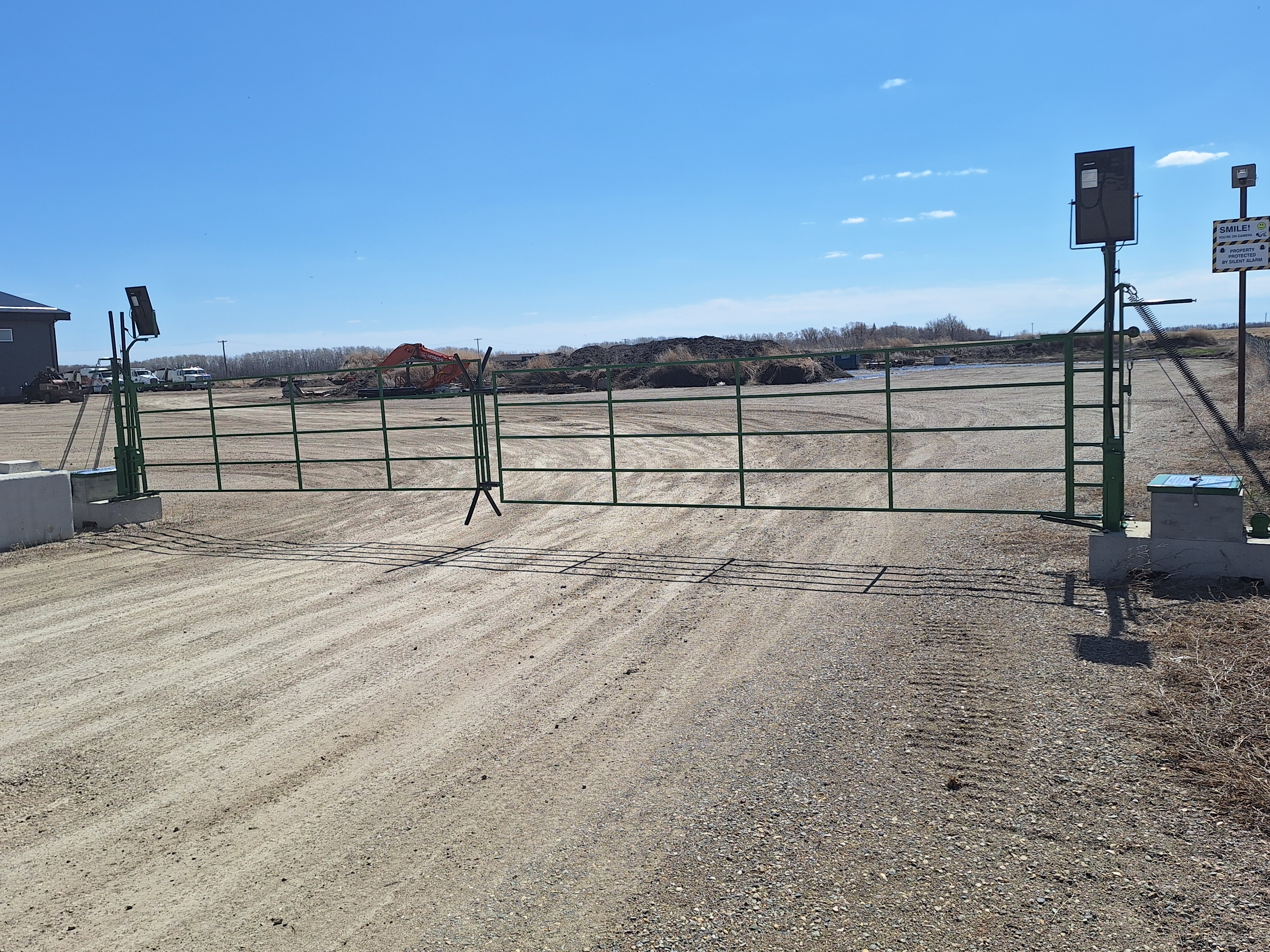 Two Lift & Go automatic gates combined for a wide 32-foot opening on a farm laneway.